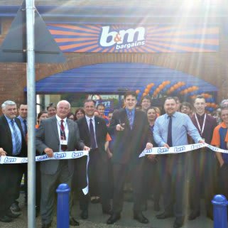 The ribbon being cut at B&M Braintree on opening day, with help from Councillor Tom Cunningham.
