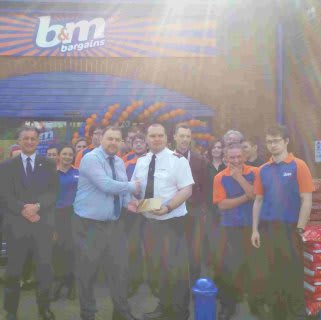 Robert Davies gratefully receiving £250 worth of B&M vouchers on behalf of the Salvation Army at B&M Braintree.