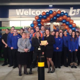 B&M Inshes's Local Hero, The Archie Foundation, gratefully receiving £250 worth of B&M vouchers as a thank you for opening the store.