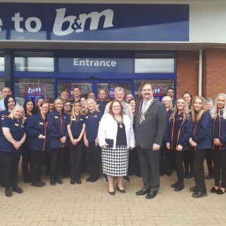 The store team at B&M's newest store in Runcorn pose in front of their wonderful new B&M Store, located at Trident Retail Park.