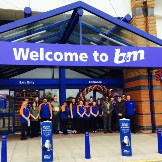 Right Worshipful the Lord Mayor of Sheffield, Councillor Talib Hussain poses with staff of the new B&M Sheffield which has moved from Unit F to Unit B (former PC World) on the Meadowhall Retail Park, Attercliffe.