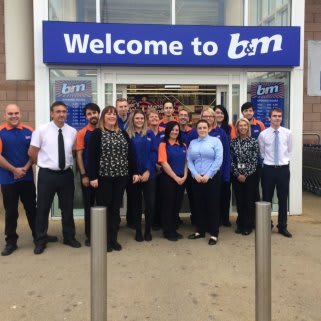 The store team pose outside their fresh new-look store at Cables Retail Park, Prescot.