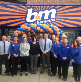Store staff pose outside the brand new B&M Bargains Store in King's Lynn, Vancouver Centre.