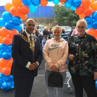 Local Mayor, Councillor Shadab Qumer welcomes the first customers through the doors of B&M Chadderton.