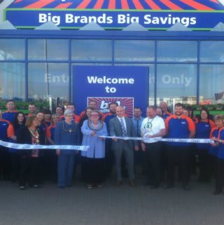 Mayor of Barrow, Councillor Ann Thomson cuts the ribbon on B&M's new store on Hindpool Road. She is joined by representatives from the store's chosen charity, Great North Air Ambulance.