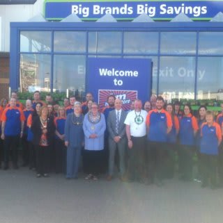 Mayor of Barrow, Councillor Ann Thomson and representatives from Great North Air Ambulance pose with store manager, Mark Finan and store staff.