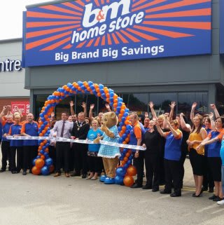 Deputy Mayor of Wirral, Pat Hacket cuts the ribbon at the opening ceremony of B&M's new Home Store & Garden Centre in Bromborough, Tebay Retail Park. Representatives from Claire House, including the Claire Bear mascot were also present and received £250 worth of B&M vouchers as a thank you.