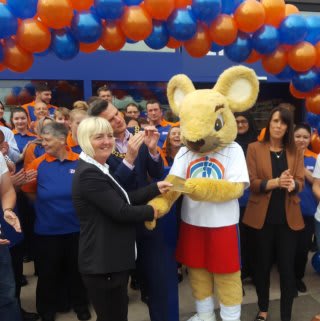 The Francis House Children's Hospice mascot is presented with £250 worth of B&M vouchers, as a thank you for taking part in the Burnage store opening.