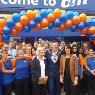 Store staff pose outside the brand new Burnage store, with Lord Mayor, Councillor Carl Austin-Behan.