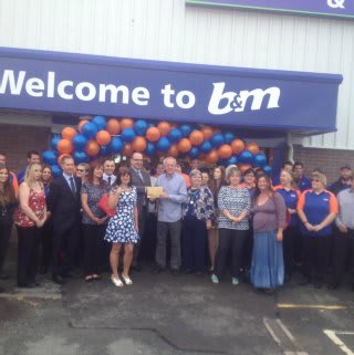 Liz, a representative of Pennar Community Hall, B&M's Local Hero for the day, gratefully receiving £250 worth of B&M vouchers.