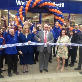 The Deputy Mayor of Peterborough, Councillor Keith Sharp, cutting the ribbon to officially open B&M Peterborough