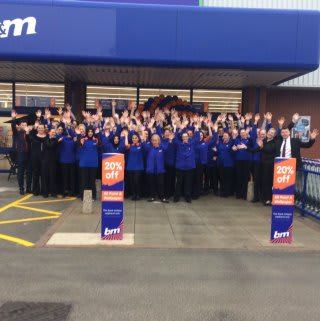 Store staff pose outside their new B&M Burton-upon-Trent store on Horninglow Road.