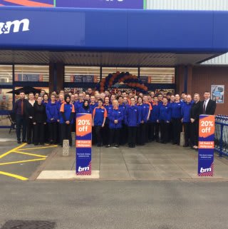 Store staff pose outside their new B&M Burton-upon-Trent store on Horninglow Road.