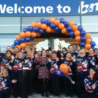 Store staff pose outside the new B&M Bargains Store at Pierpoint Retail Park, King's Lynn