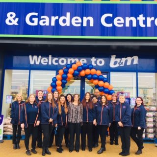 Store staff at B&M's new store in Leighton Buzzard (located at Grovebury Retail Park) pose in front of the purpose built B&M Home Store & Garden Centre.