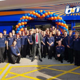 The store team at B&M's newest store in Lydney pose in front of their wonderful new B&M Store, located on Hams Road.