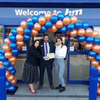 B&M Goldington's store manager welcomes local charity Faces on opening day. The charity received £250 worth of B&M vouchers as a thank you for taking part in B&M's special day,