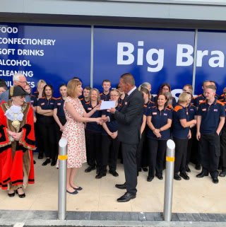 A representative from The Charles Burrell Centre receives £250 worth of B&M vouchers. The donation was made as a thank you for the charity's hard work in the local community.