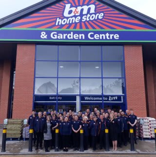 The store team at B&M's newest store in Sandbach pose in front of their brand new Home Store & Garden Centre, located on Old Mill Road.