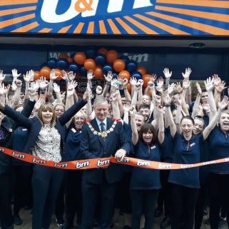 Store staff at B&M's newest store in Dover celebrate as local mayor, Councillor Gordon Cowan cuts the ribbon to officially open the store.