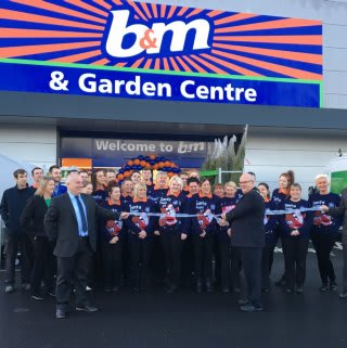 Store staff pose with Mayor of Featherstone, Cllr Steve Vickers as he cuts the ribbon at B&M's new Featherstone store.