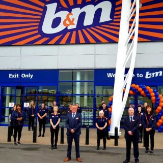 The store team at B&M's newest store in Lisburn pose in front of their wonderful new B&M Store, located at Sprucefield Retail Park.