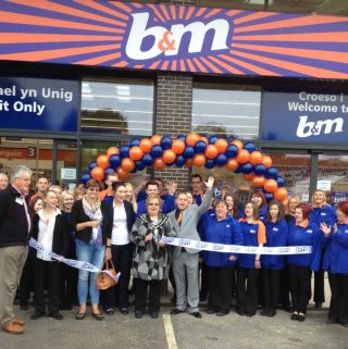 The ribbon being cut at B&M Welshpool by Deputy Mayor, Hazel Evans, and Rosanne Corfield from the Heulwen Trust.