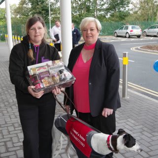 Greyhound Rescue organiser Tracy Cook receives a gift and £250 worth of B&M vouchers from store manager Julie Trainor.