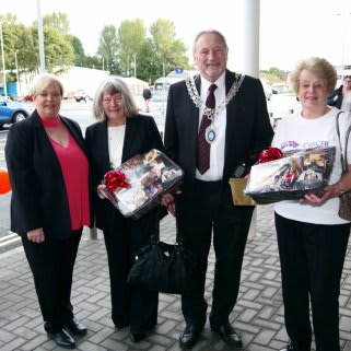 B&M Guisborough store manager Julie Trainor presents Guisborough Town Council Mayor Dennis Teasdale with a donation to Cancer Research UK.