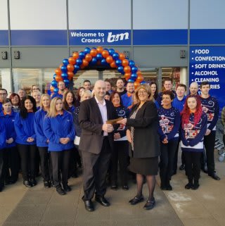 Representatives from charity Ty Olwen Trust accepted £250 worth of B&M vouchers, as a thank you for being the retailer's special guests at its new store opening in Swansea.
