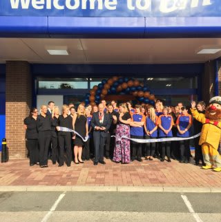 Store staff are joined by representatives from RNLI who cut the ribbon at the B&M Poole store opening